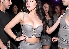 Beautiful brunette in grey leather outfit and boots teasing a guy by dancing lasciviously in a