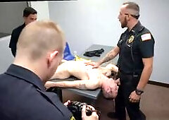 Two mature men take care of a naked gay cop in a steamy threesome