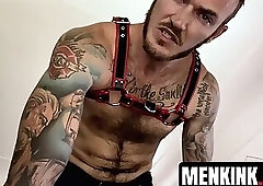 Hairy Christian Wilde in leather clothing wanks his hard cock until cumshot