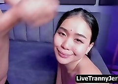 T-girl showers her load all over the face of an Asian beauty.