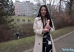 Asian woman deep-throats a realistic dildo on a public pathway