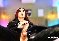 Redhead trans in latex suit jerking her hard cock