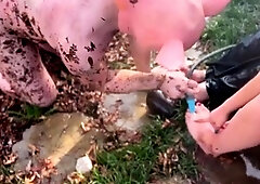 Foot slave being taught servitude and obedience outdoors