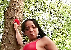 Tgirl in red lingerie exposes round breasts and massive ass