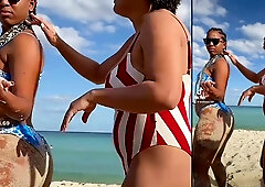 Two dark-skinned brunettes grind clits in a hotel after a beach day with a tattooed man joining