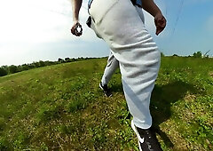 Freeballing walk in nature with a good-sized sweatpants erection
