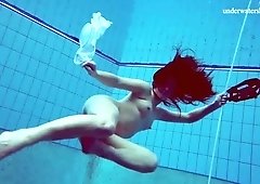 Lovely natural chick exposes her sexy rounded ass and natural tits underwater