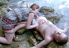 French redhead Marie Clarence takes anal pleasure on a rocky seaside shore