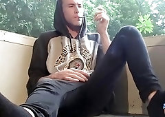 Gay twink smoking alone and tugging on his massive schlong
