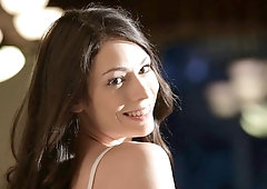 Soloing black-haired hottie Arwen Gold stimulates her little pussy