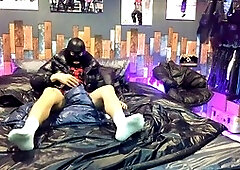 Guy in nylon shorts enjoying handjob on a shiny bed