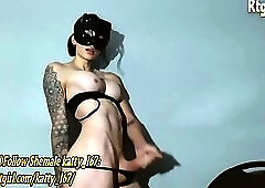 masked slender trans hottie with tattoos and big tits jerks off her big thick cock