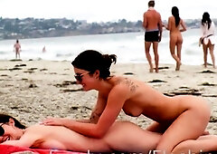 Lesbian milfs explore each other's naked curves on the beach