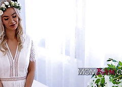 Blonde MILF Angelica Coralvine plays stepmom in white bridal lace before intimate moments on the couch