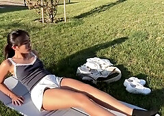 Horny babe plays with sex toy in public park