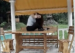 Marvelous brunette hair masturbates outdoors.
