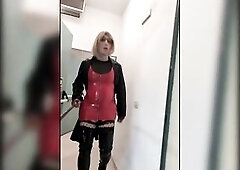 Public walk in overknee boots in a parkhouse, clothed in nylons, red pvc suit and leather coat. Sexy blond.