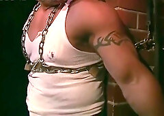 Muscular Construction Worker Is Bound With Chains