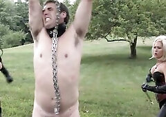 two sadistic Femdom are whipping a hanged serf