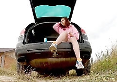 This babe's despairing to pee but her pee aperture doesn't wanna relax. So this babe smokes sitting in the trunk of my car, trying to relax 