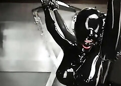 Stacked babe in latex bodysuit gets tied up and gagged