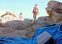 Exposed on the rocks: a public handjob leads to a cumshot under the sun