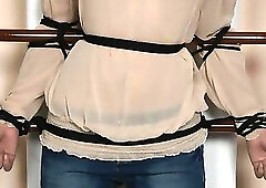 Brunette girl stands still bound