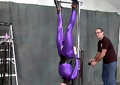 suspended in purple catsuit