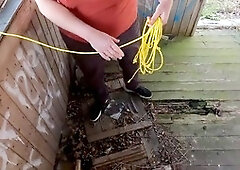 Walking on the veranda in a bare chastity belt