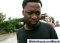 Black homeboy cradles white guys balls