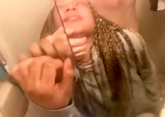 Blasian bent over bathroom sink while roommates in other room