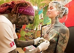 Tattooed girl Lily Lu experiences an anal invasion while getting her nipple piercings done
