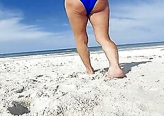 Crossdresser wearing blue tie side bikini at public beach