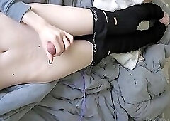 skinny femboy strokes big cock on bed