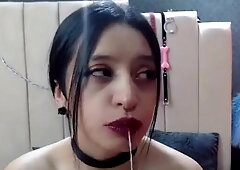 Good brunette with bright red lips is sucking her nice white dildo