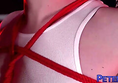 Muscular jock bound in red rope takes it bareback in a wrestling ring dungeon