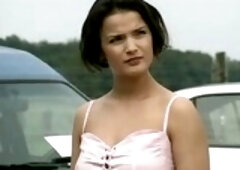 Naughty girl is having sex with two guys in front of a garage they are working in