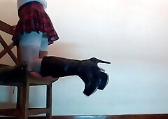 Crossdressing shemale in teases in a sexy skirt and boots