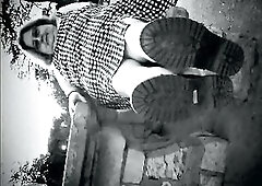 Nurse vicki models in her ebony and whot hogwarts outfit and spiked boots