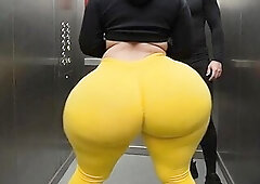 Description: A curvy thick cutie with a giant butt dances softly in the elevator wearing constricted yellow leggings. Her heavy round buns bounce and 