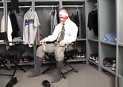 Hunk in shirt and tie bound to chair gagged and blindfolded