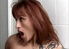 Fiery redhead MILF devours tattooed stud's cock in the bathroom