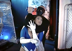 Brunette superheroine in blue mask stripped down under surveillance