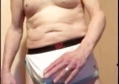 Amateur daddy moans loudly while jerking off through mesh shorts and cums