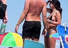 Topless beach girl in blue thong