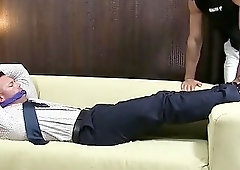 Tied up businessman has his bare feet licked and sucked