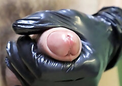 fetish in mittens close-up leaking a plenty of of oil from the crimson head