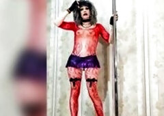 lewd Sissy slut tries on a fresh red high-heeled bodysuit in front of the camera in a purple miniskirt, with a recent hairy hairstyle, wearing lace gl