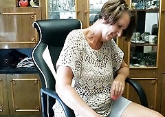 A lonely housewife visiting a ally sways in a chair, shows her butt, takes off her shorts out of underclothing and plays with a cat.