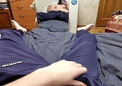 Young russian man in sweatpants and balaclava drains off